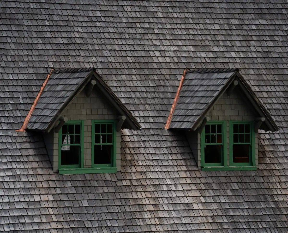 Dormers on a shingle roof in Salinas, CA, where step flashing and kickout flashing carry water past the walls